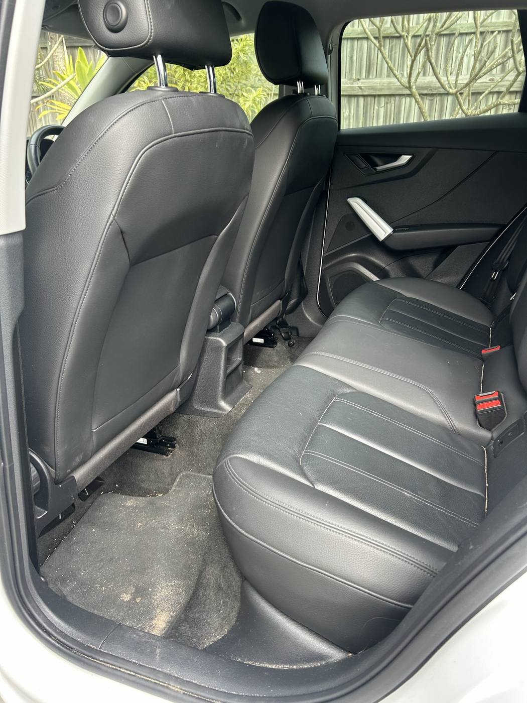 Rear seats and floor before detailing — dirt through the carpet