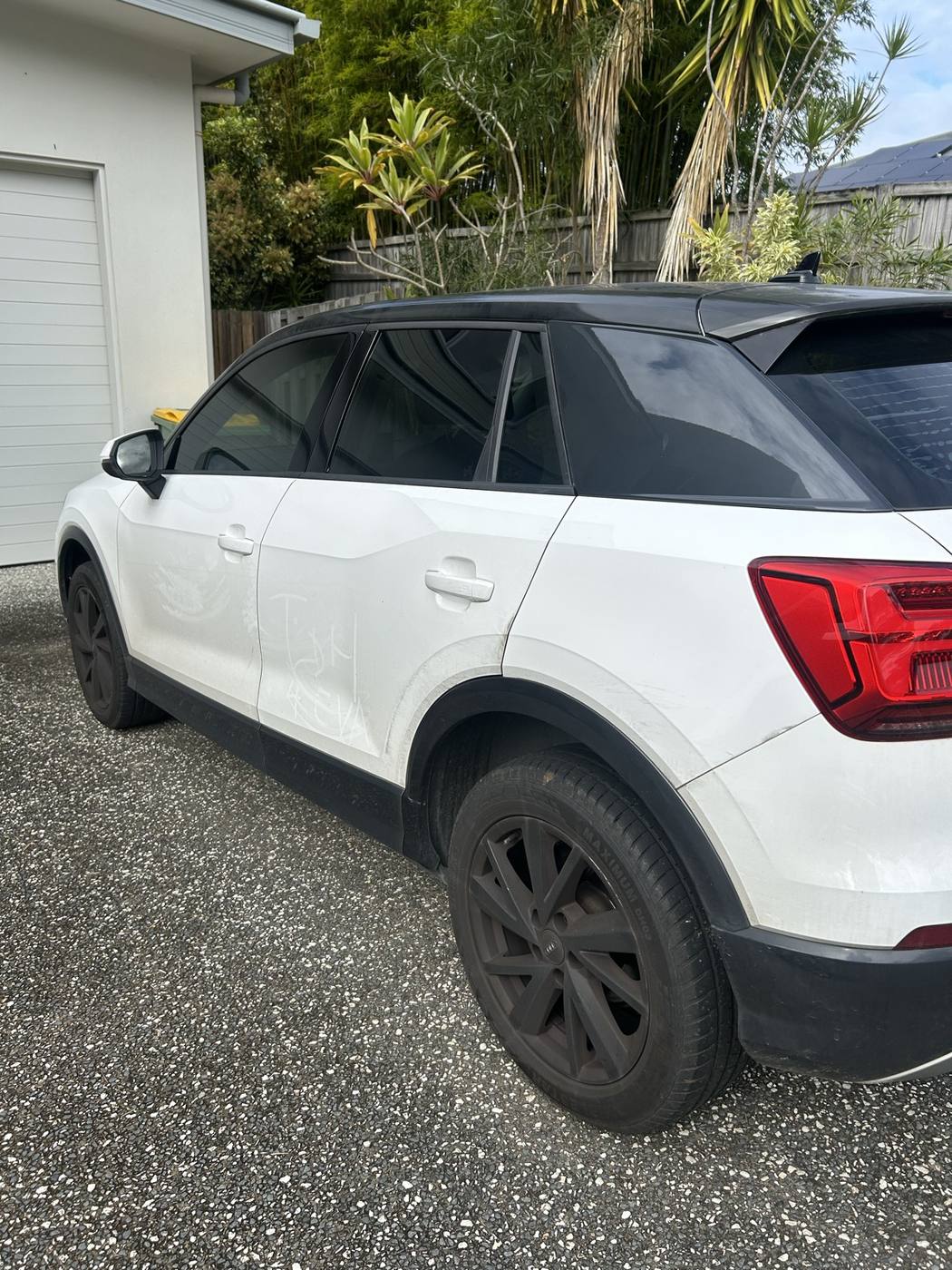 Audi Q2 side panel before detailing — covered in road dust