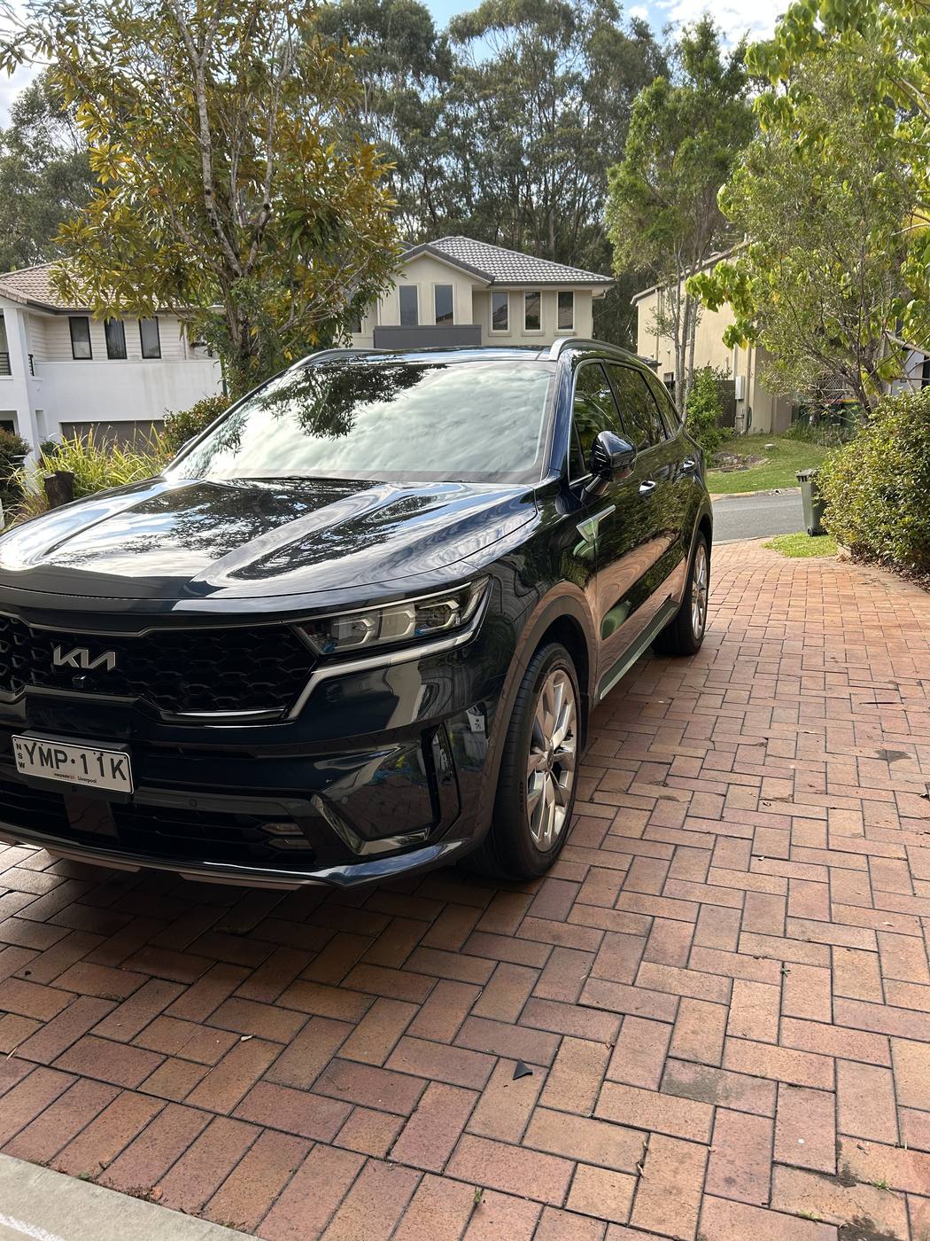 Kia Sorento after detailing — deep gloss black paint
