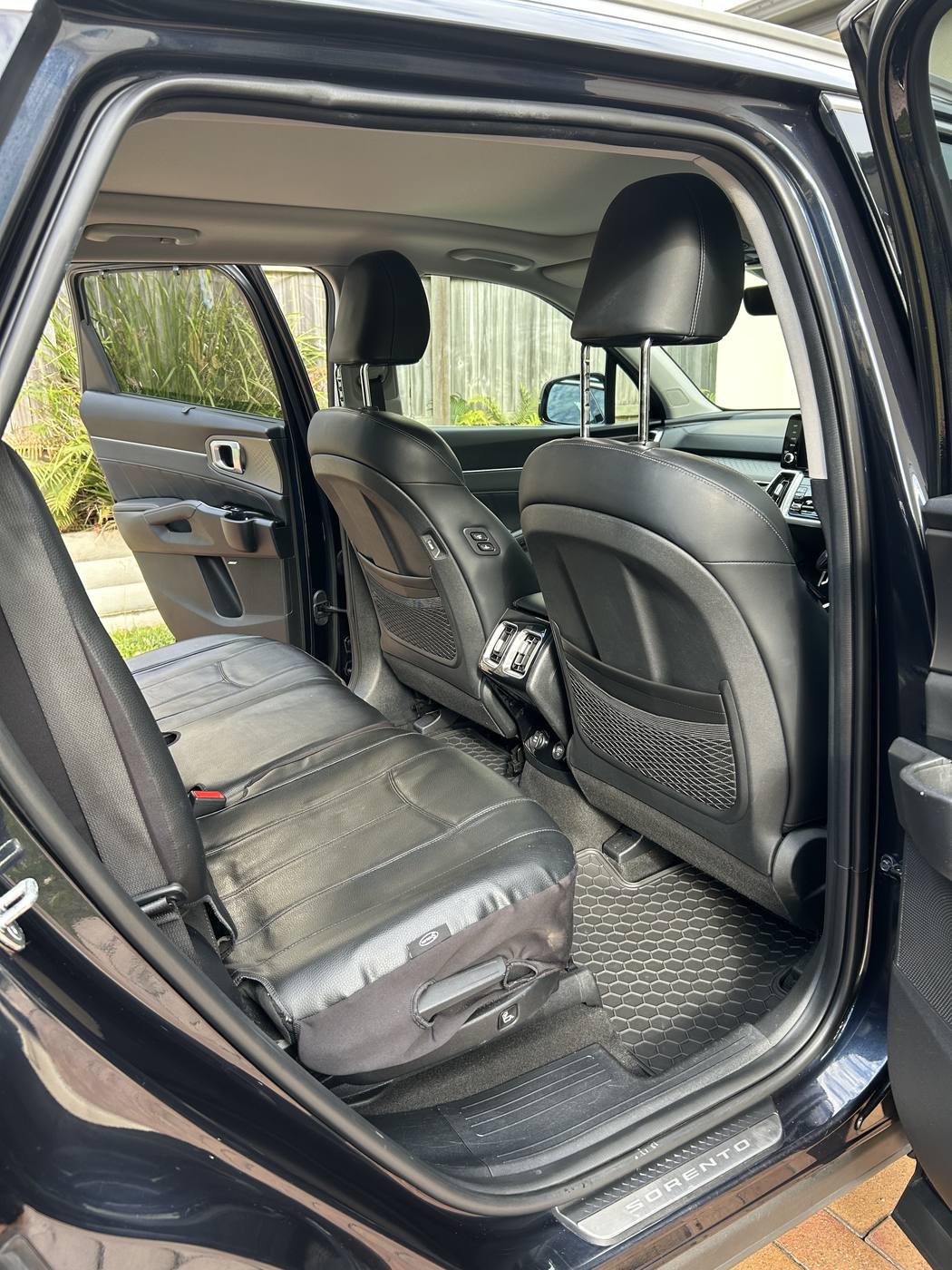 Kia Sorento rear seats after detailing — clean leather and fresh mats