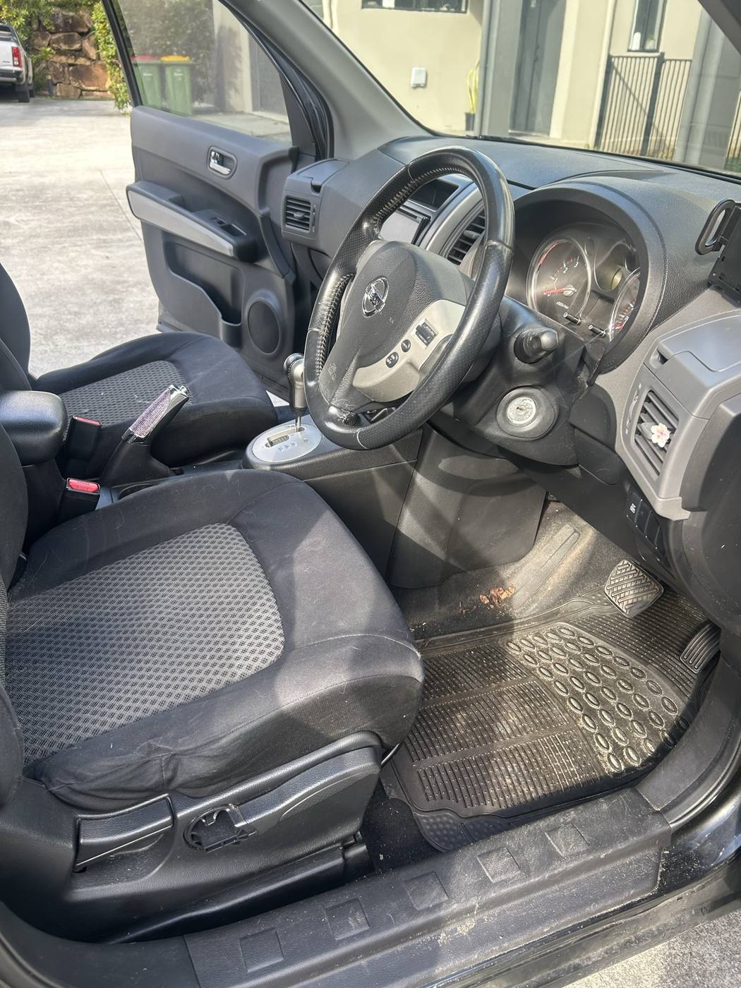 X-Trail driver cabin before detailing — dusty dash and dirty floor