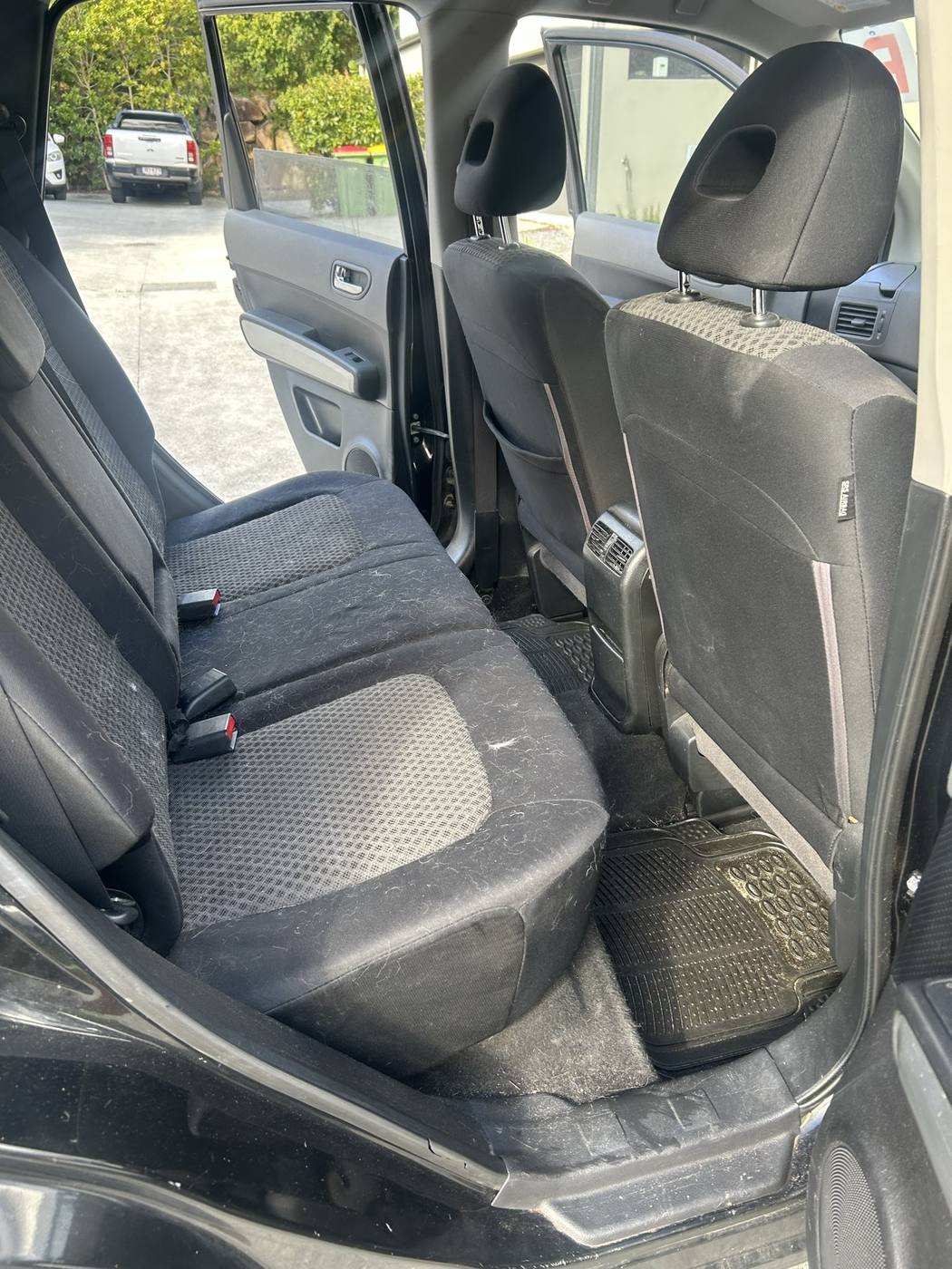 X-Trail rear seats before detailing — lint, hair and dirt on the fabric