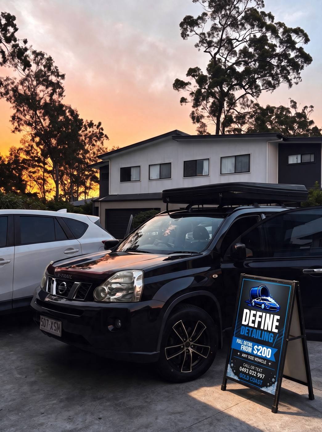Define Detailing A-frame sign beside a freshly detailed Nissan X-Trail at sunset on the Gold Coast